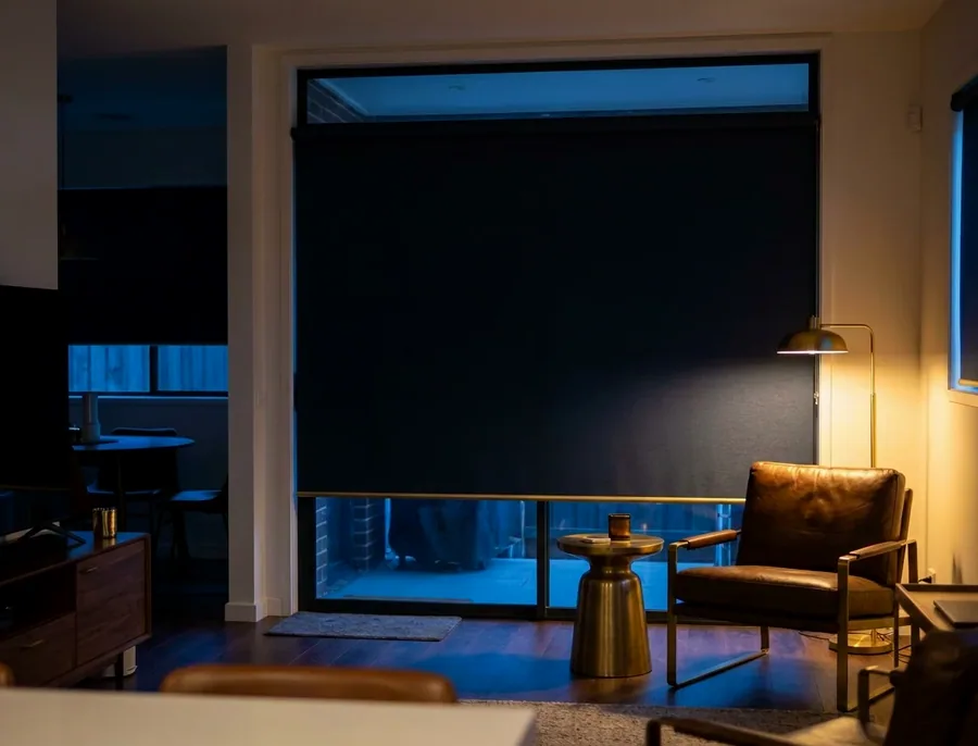 Blockout roller blind lowered over a large sliding door in a Bryanston home
